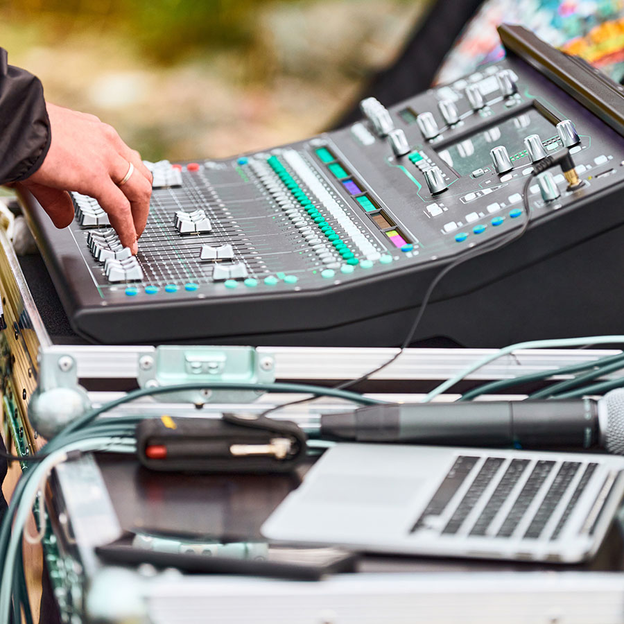 Sound Engineer Behind Mixing Desk